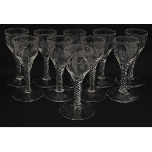 244 - Ten Georgian drinking glasses with air twist detail to stems, the bowls engraved with floral and fol... 