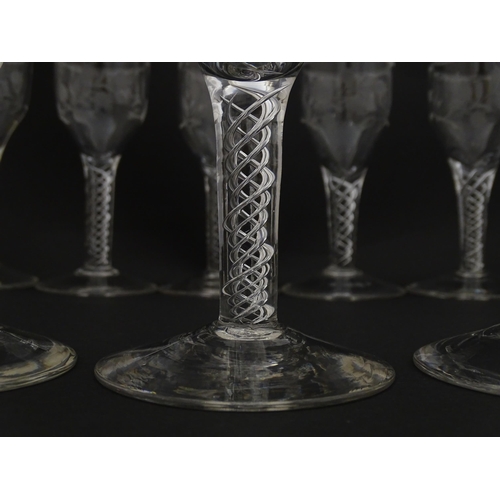 244 - Ten Georgian drinking glasses with air twist detail to stems, the bowls engraved with floral and fol... 