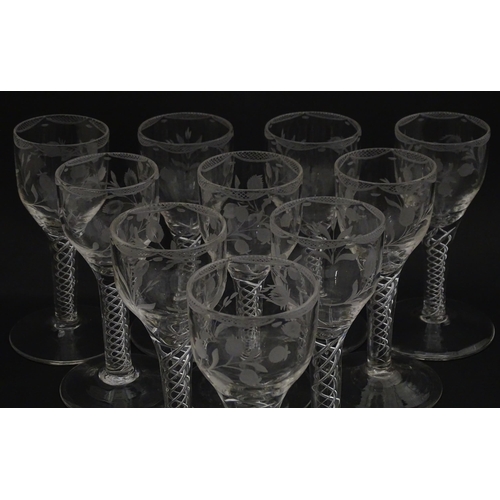 244 - Ten Georgian drinking glasses with air twist detail to stems, the bowls engraved with floral and fol... 