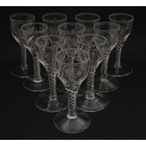 244 - Ten Georgian drinking glasses with air twist detail to stems, the bowls engraved with floral and fol... 