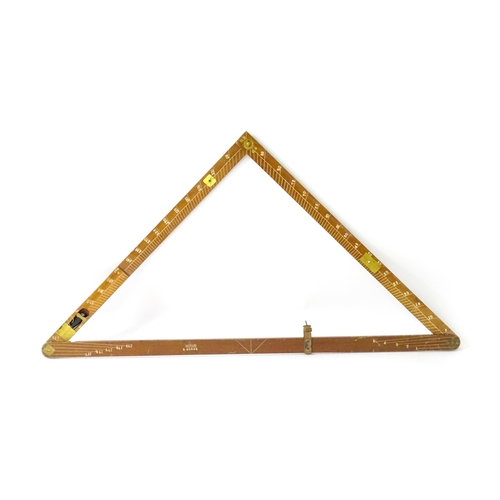 1150 - An M.D.S. Ltd. surveyor's folding triangle rule with inset spirit level and plumb bob. No. B.49645. ... 