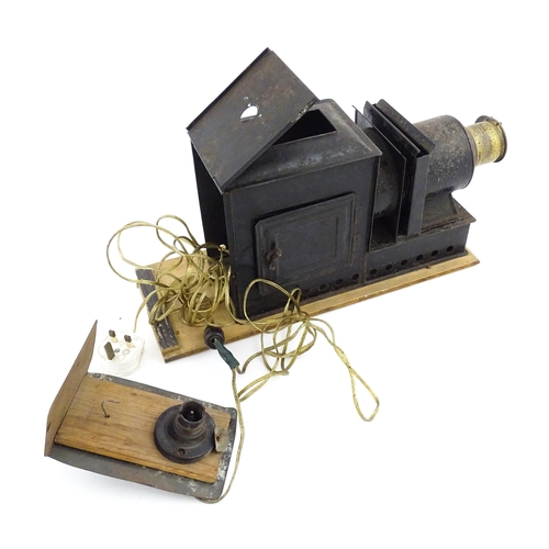 1186 - A Victorian tinplate Magic Lantern with various slides to include Cinderella, Welcome, Good Night, e... 