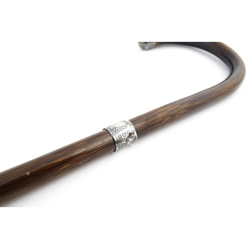 1253 - An early 20thC child's peacock wood walking cane, with silver collar and handle tip, hallmarked Lond... 