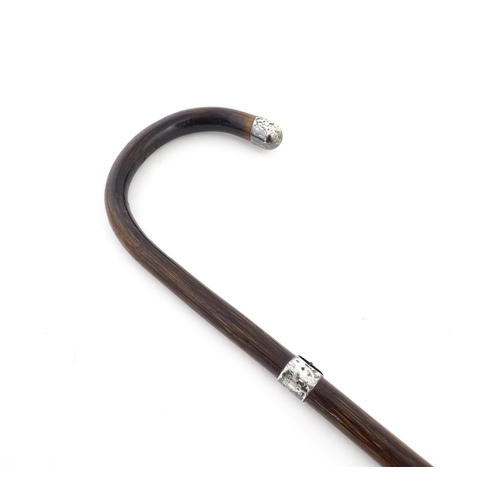 1253 - An early 20thC child's peacock wood walking cane, with silver collar and handle tip, hallmarked Lond... 