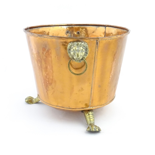 1260 - A late 19th / early 20thC copper log bucket / planter with twin brass lion mask ring handles and thr... 