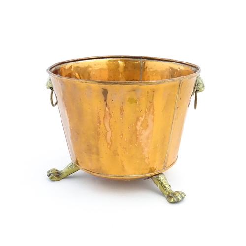 1260 - A late 19th / early 20thC copper log bucket / planter with twin brass lion mask ring handles and thr... 