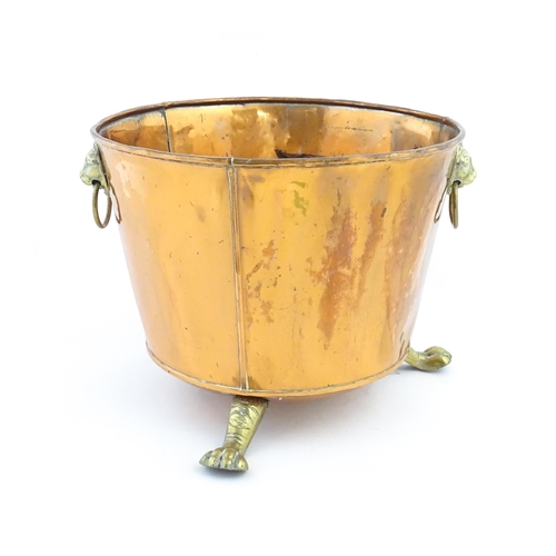 1260 - A late 19th / early 20thC copper log bucket / planter with twin brass lion mask ring handles and thr... 