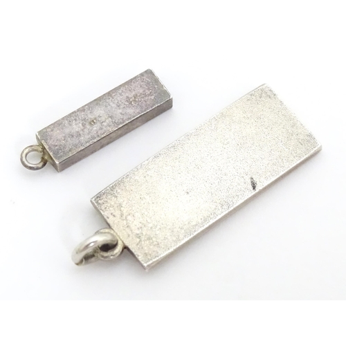 677 - Two silver pendants of ingot form, one hallmarked Birmingham 1979, the other hallmarked London 1978.... 