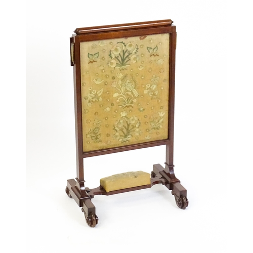 1390 - A late 19thC mahogany fire screen with a hinged shelf attatched to the top of the frame, the central... 