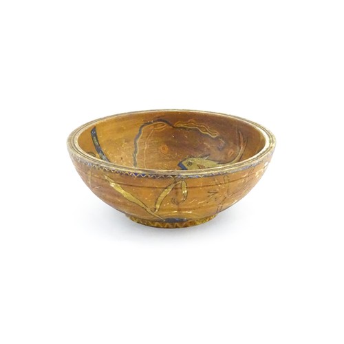 1153 - An early 20thC naive / folk art wooden bowl with hand painted decoration depicting stylised fish and... 