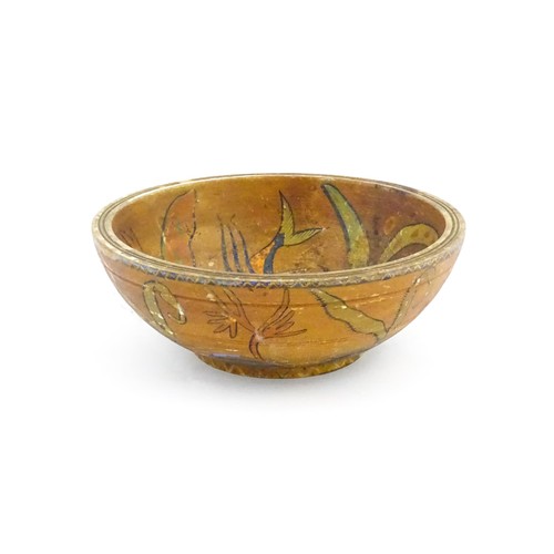 1153 - An early 20thC naive / folk art wooden bowl with hand painted decoration depicting stylised fish and... 