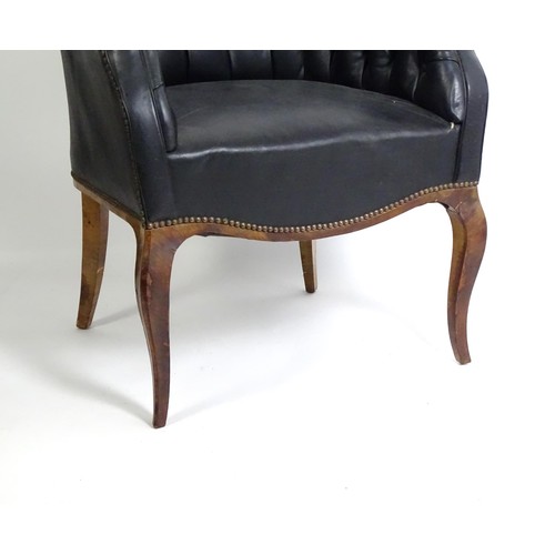 1405 - A mid 20thC deep buttoned leather armchair, raised on cabriole front legs and tapering back legs. 30... 