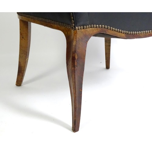 1405 - A mid 20thC deep buttoned leather armchair, raised on cabriole front legs and tapering back legs. 30... 