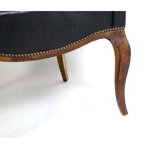 1405 - A mid 20thC deep buttoned leather armchair, raised on cabriole front legs and tapering back legs. 30... 