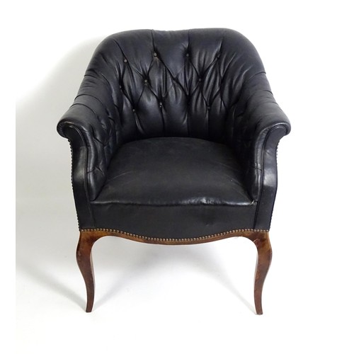 1405 - A mid 20thC deep buttoned leather armchair, raised on cabriole front legs and tapering back legs. 30... 