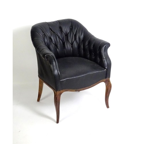 1405 - A mid 20thC deep buttoned leather armchair, raised on cabriole front legs and tapering back legs. 30... 