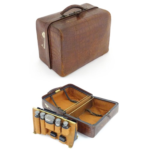 602 - A lather vanity / valise travelling case having fitted section within with various Victorian silver ... 