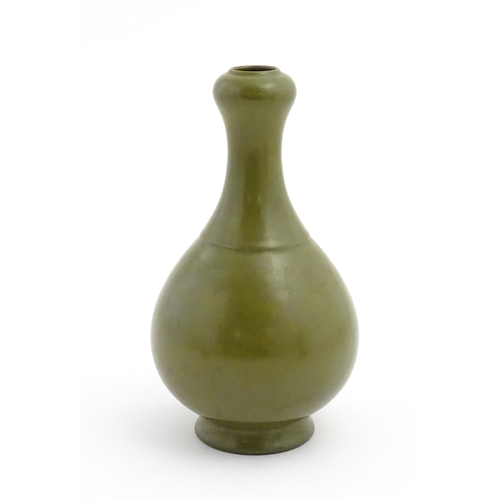 34 - A Chinese bottle vase with tea coloured glaze. Character marks under. Approx. 11