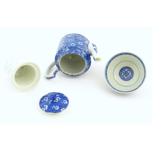 35 - A Chinese blue and white teapot decorated with prunus blossom. Together with a Chinese blue and whit... 