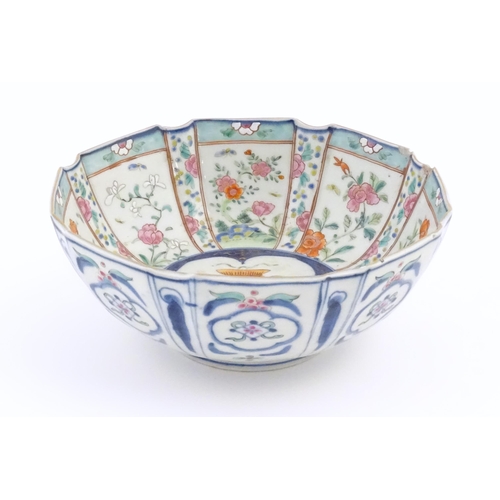 43 - An Oriental famille rose bowl of octagonal form decorated with flowers, foliage and butterflies / in... 