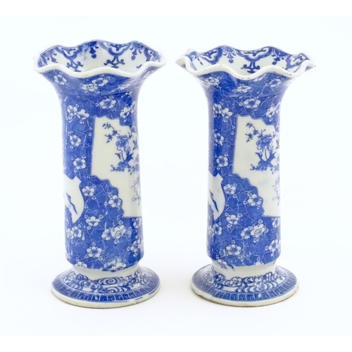 60 - A pair of Oriental blue and white vases with lobed flared rims, decorated with flowers and foliage. ... 