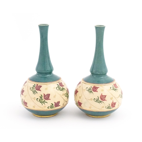 160 - A pair Royal Doulton bottle vases with turquoise ground and banded pink rose detail. Marked under. A... 