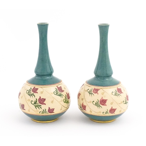 160 - A pair Royal Doulton bottle vases with turquoise ground and banded pink rose detail. Marked under. A... 