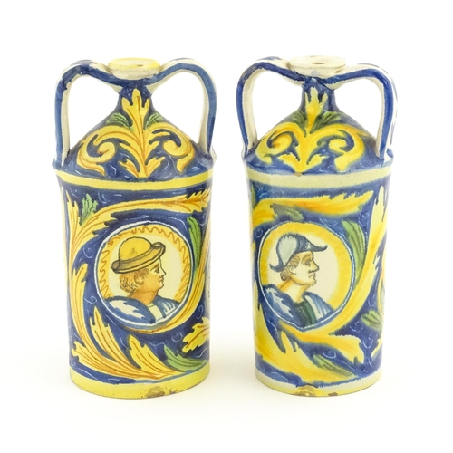 210 - Two Italian maiolica twin handled bottle jars, each decorated with foliate detail and a portrait bus... 