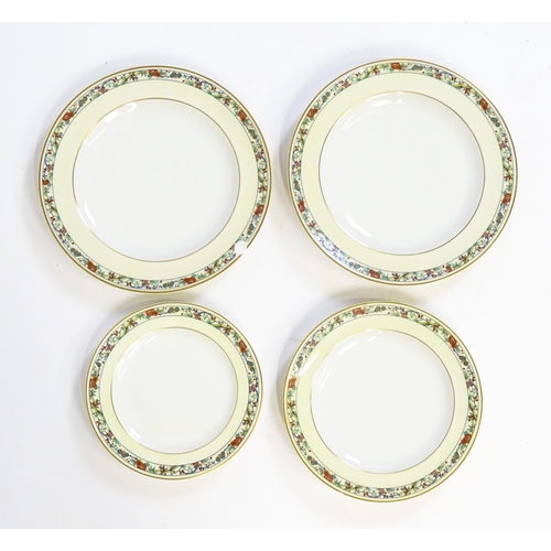 219 - A quantity of Haviland Limoges dinner wares with banded foliate border, to include plates, serving p... 