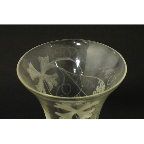 238 - A 19thC pedestal drinking glass with double air twist and etched bird and fruiting vine detail. Appr... 