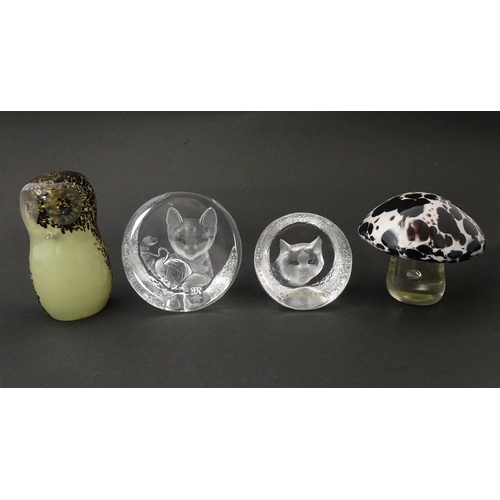 287 - Four 20thC glass paperweights, comprising a Wedgwood owl, two Mats Jonasson cats and a white/purple ... 