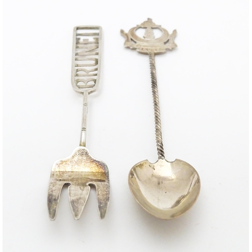 460 - A white metal souvenir fork titled Brunei to handle. Together with a white metal teaspoon also title... 