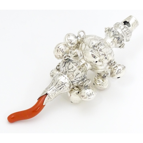 516 - A .925 silver baby's rattle with ten bells and coral branch. Approx 5