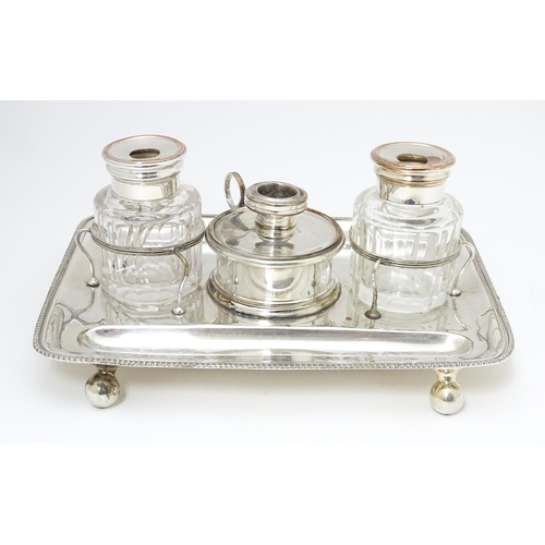 565 - Silver plate : A 19thC Old Sheffield Plate inkstand / standish with central taper / wax jack contain... 