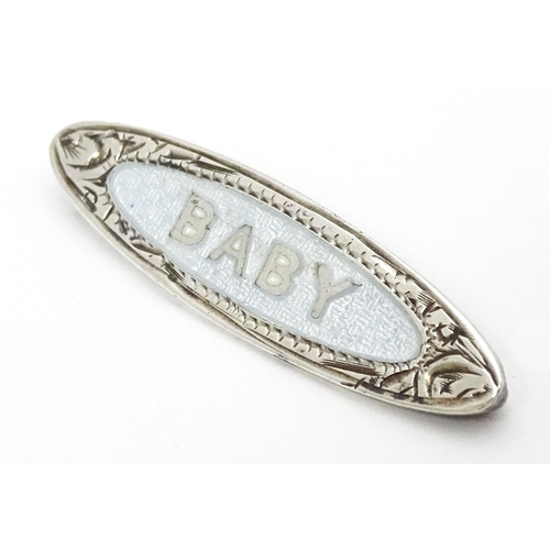 660 - A silver brooch with guilloche enamel decoration titled Baby, marked A.J.C. Sterling. Approx. 1 1/2