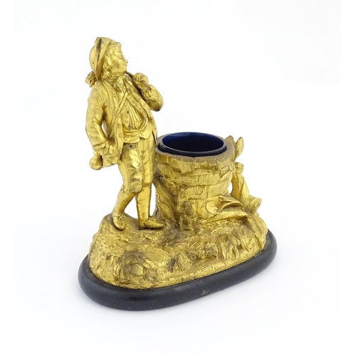 1041 - A late 19th / early 20thC gilt bronze figural spill vase modelled as a young man holding a basket of... 