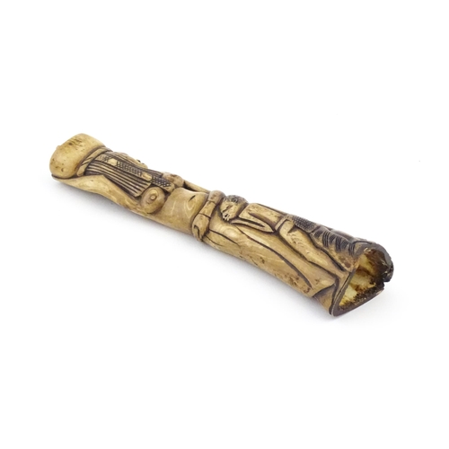 1125 - Ethnographic / Native / Tribal : An African carved bone with figural detail. Approx. 9 3/4