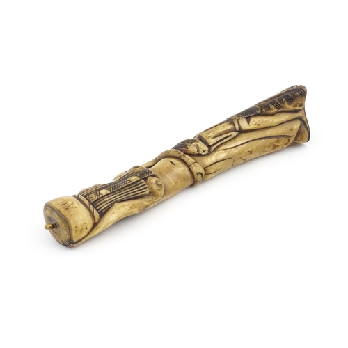 1125 - Ethnographic / Native / Tribal : An African carved bone with figural detail. Approx. 9 3/4