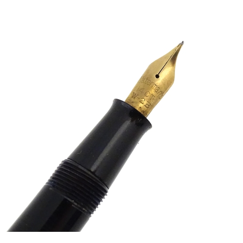 1161 - A 20thC boxed Waterman's Champion 501 black fountain pen with 14ct gold W-2B nib, matching propellin... 