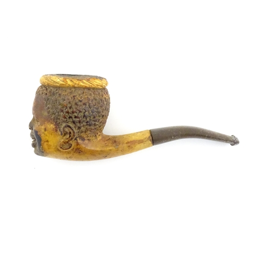 1175 - A 19thC carved meerschaum pipe the bowl depicting a smiling boy. Within a fitted case with retailers... 