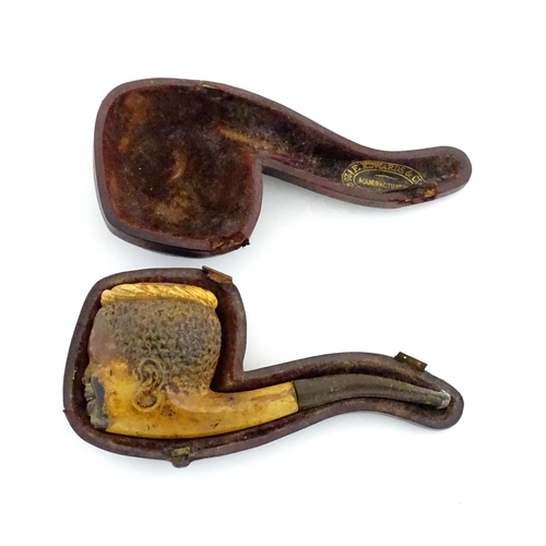 1175 - A 19thC carved meerschaum pipe the bowl depicting a smiling boy. Within a fitted case with retailers... 