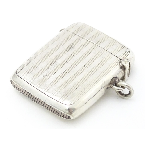 300 - A silver vesta case with engine turned decoration, hallmarked Birmingham 1907, maker William Hutton ... 