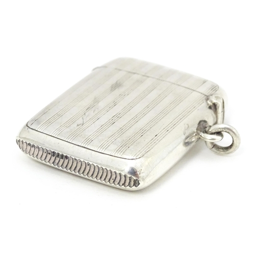 300 - A silver vesta case with engine turned decoration, hallmarked Birmingham 1907, maker William Hutton ... 