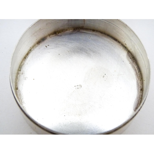 304 - A .925 silver pill box of circular form decorated to lid with images of an aeroplane, airship, boats... 