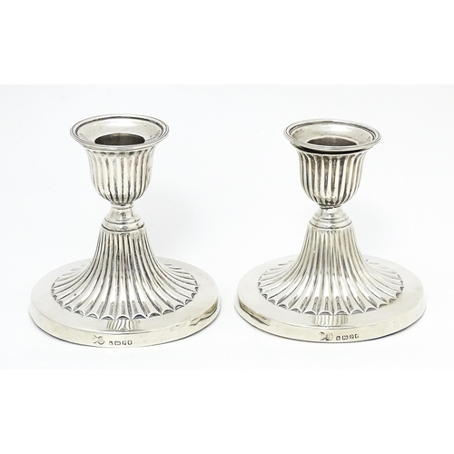 310 - A pair of Victorian short candlesticks with fluted decoration hallmarked Sheffield 1882, maker Elkin... 