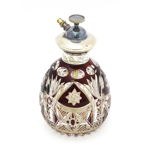 318 - A cut glass scent bottle / atomiser with ruby glass detail and silver collar, marked Sterling Silver... 