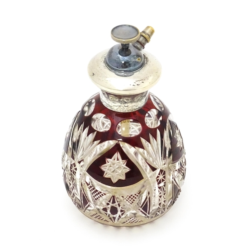 318 - A cut glass scent bottle / atomiser with ruby glass detail and silver collar, marked Sterling Silver... 