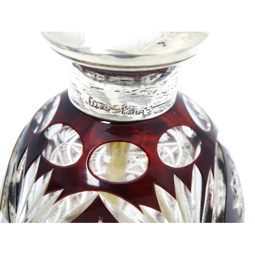 318 - A cut glass scent bottle / atomiser with ruby glass detail and silver collar, marked Sterling Silver... 