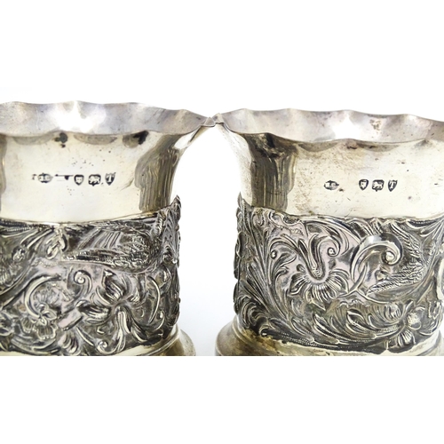 329 - Three Victorian silver bottle coasters with floral scroll and bird detail and flared rims, hallmarke... 