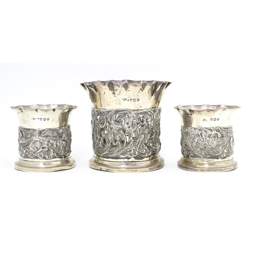 329 - Three Victorian silver bottle coasters with floral scroll and bird detail and flared rims, hallmarke... 